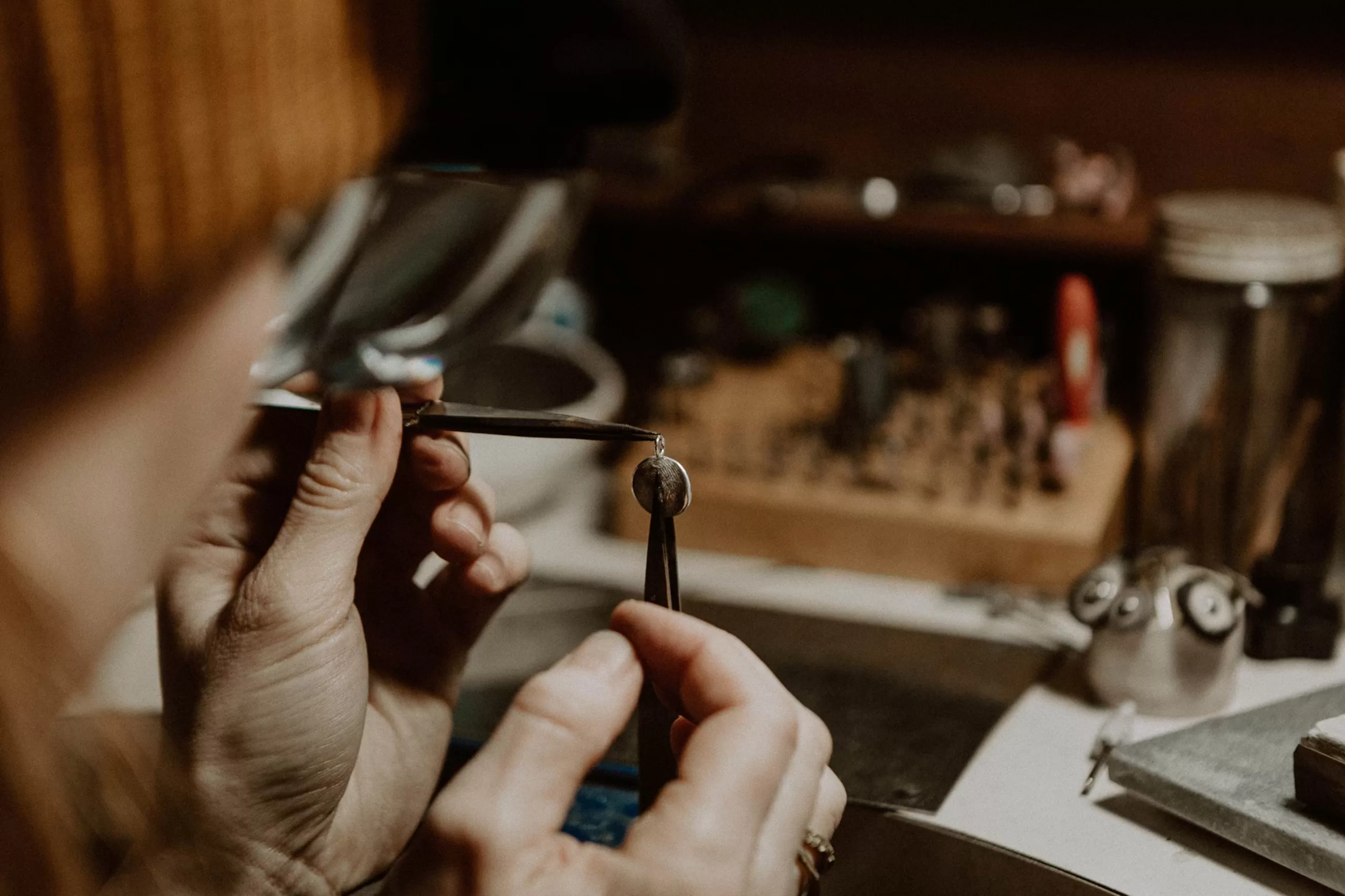 Gemma in the workshop working on a silver fingerprint impression necklace